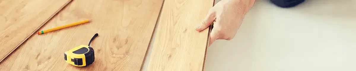 A professional installing wood flooring in Seattle, WA
