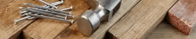 Hammer and nails on hardwood flooring boards in Seattle, WA