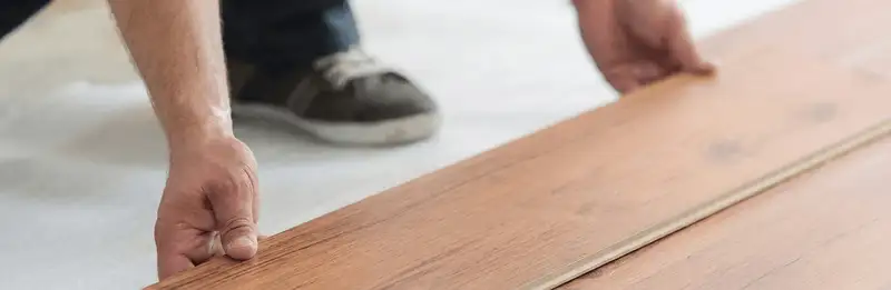 A professional installing laminate flooring in Seattle, WA